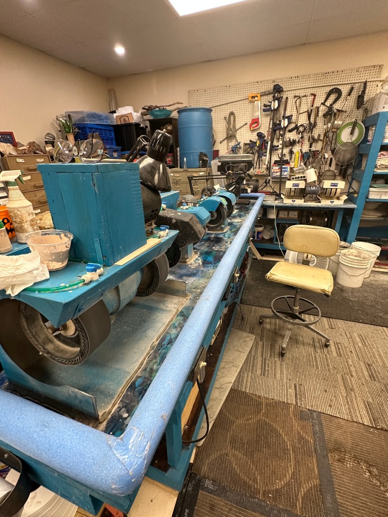 View of a lapidary workstation with polishing equipment and tools in a museum.