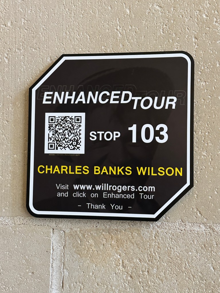 Sign for Enhanced Tour Stop 103, featuring a QR code and the name Charles Banks Wilson.