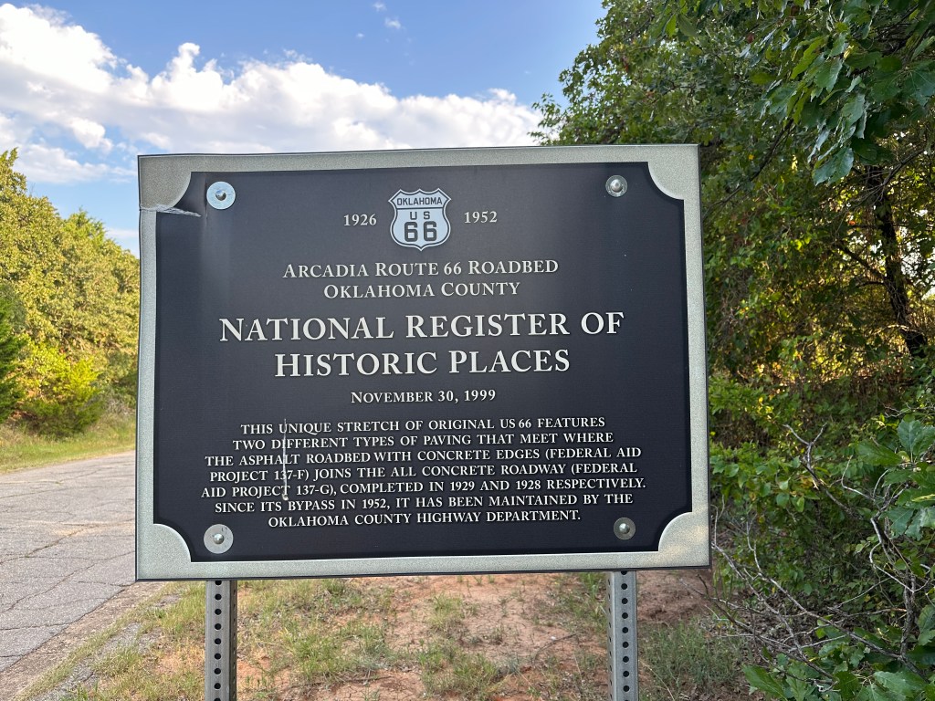 Historic marker for Arcadia Route 66 Roadbed in Oklahoma, indicating its inclusion in the National Register of Historic Places.