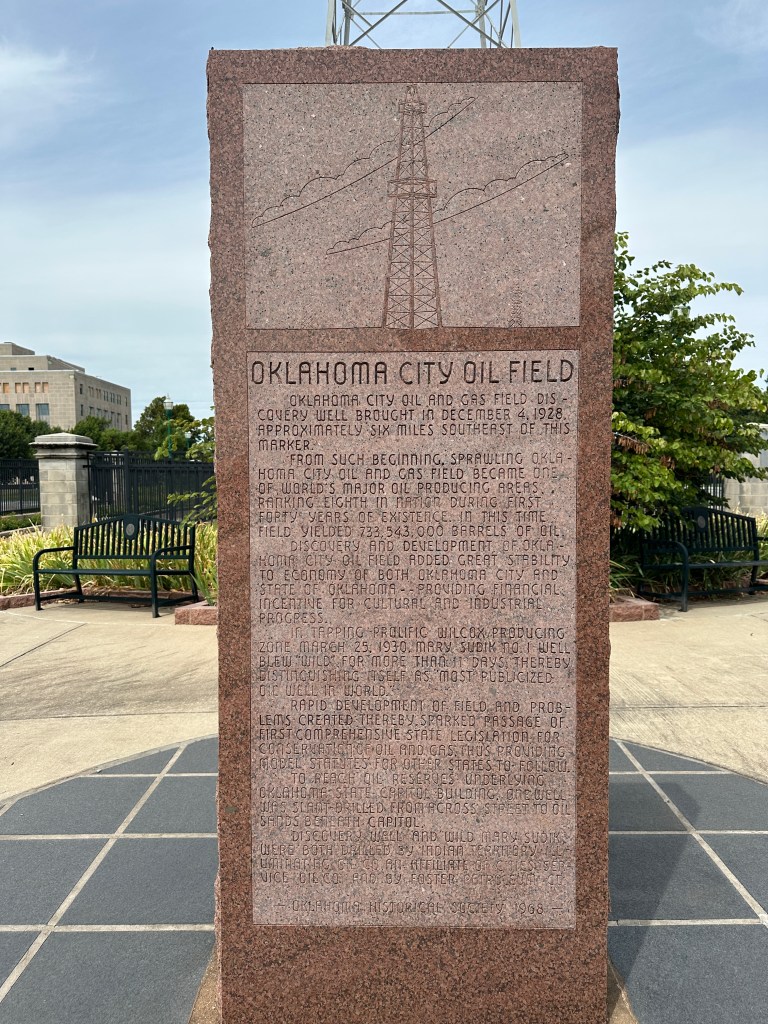 Historical marker commemorating the Oklahoma City Oil Field, featuring engraved text about its discovery and significance in Oklahoma's economic development.