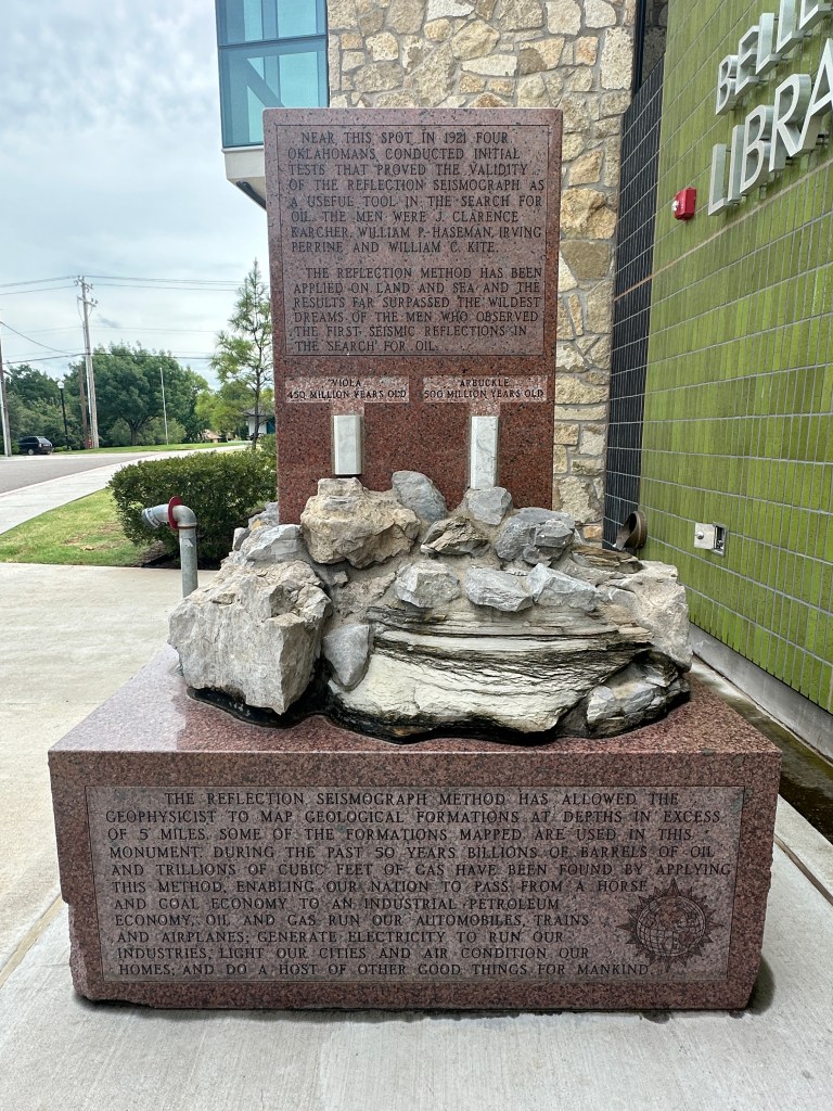 Historic marker at Belle Isle Library, Oklahoma, commemorating the Birthplace of the Reflection Seismograph, detailing historical findings and contributions to oil prospecting.