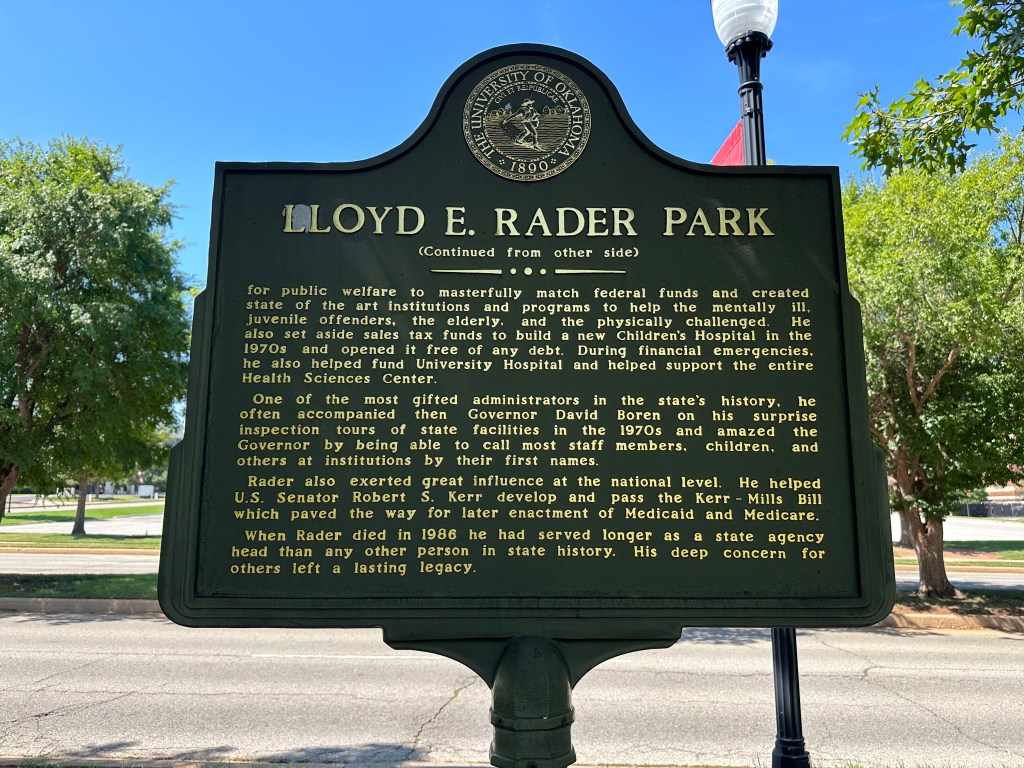 Historic marker for Lloyd E. Rader Park, detailing the contributions of Lloyd E. Rader to public welfare and healthcare in Oklahoma.