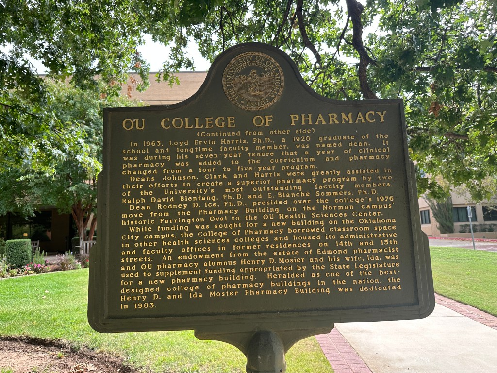 Historic marker for the OU College of Pharmacy, detailing the history and establishment of the pharmacy program at the University of Oklahoma Health Sciences Center.