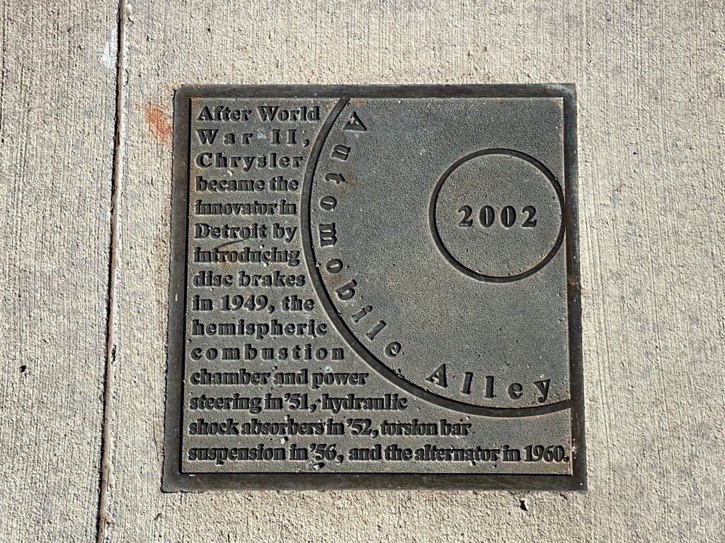 Historic marker plaque for Automobile Alley in Oklahoma City, detailing Chrysler's innovations in the automotive industry post-World War II.