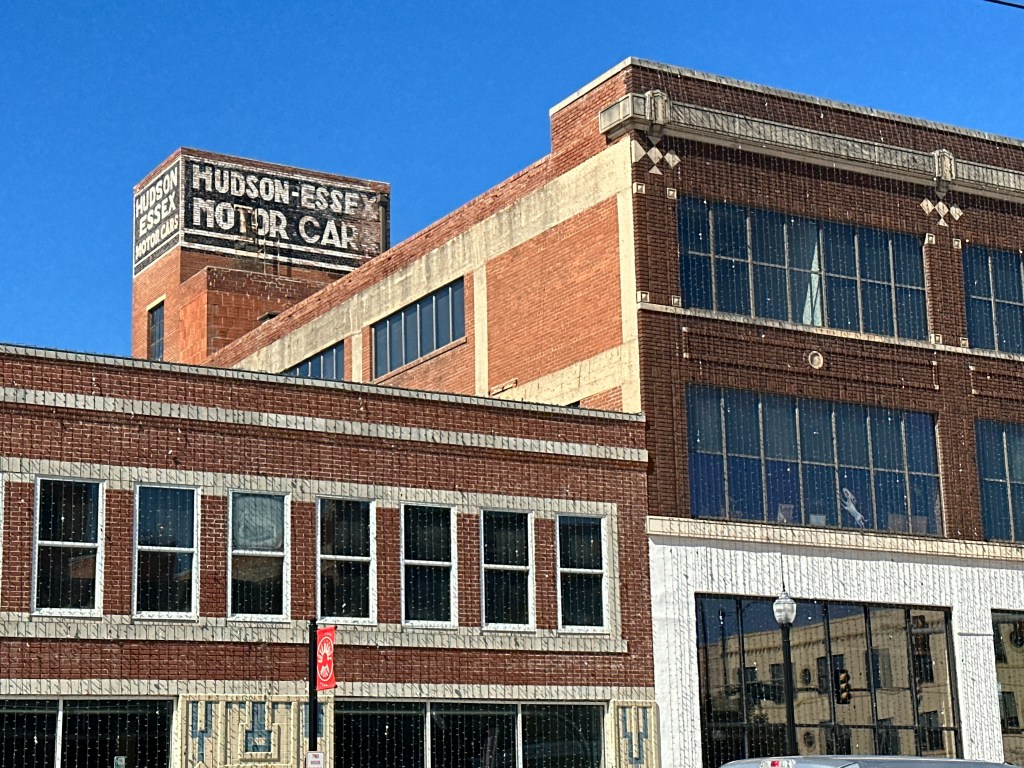Historic building in Automobile Alley featuring a visible sign that reads 'Hudson-Essex Motor Car' against a clear blue sky.