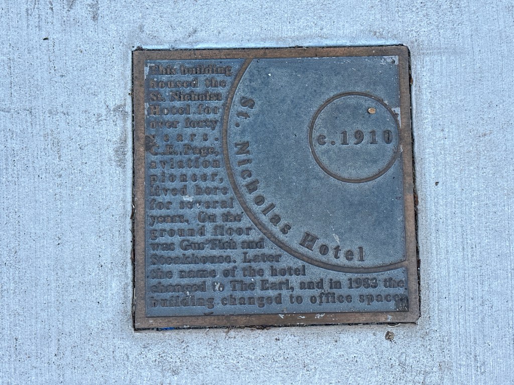 Historic marker plaque for the St. Nicholas Hotel in Automobile Alley, Oklahoma City, detailing its history and significance.