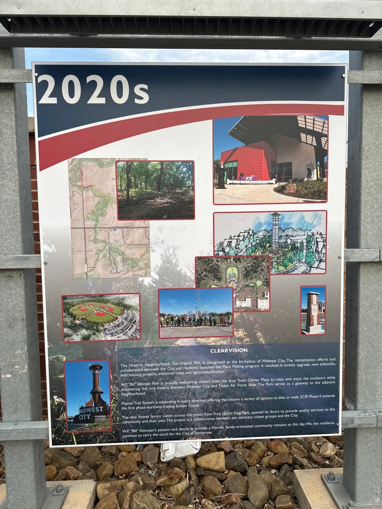 Informational sign marking the 2020s in Midwest City, featuring images of community projects, revitalization efforts, and trail expansions.
