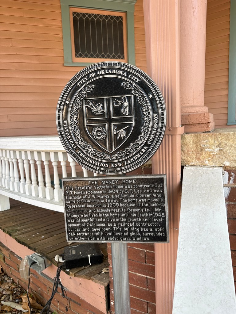 Historic plaque detailing the Maney Home, a Victorian house built in 1904, located at 917 North Robinson in Oklahoma City. The plaque provides information about its construction and significance in local history.