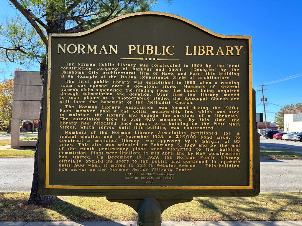 Historic marker for the Norman Public Library, detailing its construction in 1929 and historical significance.