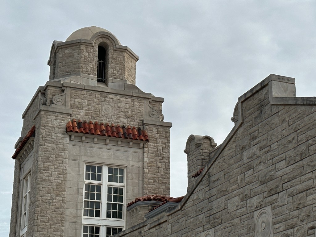 Close-up view of the tower and architectural details of the Union Station in Oklahoma City, highlighting the stonework and clay tile roof.