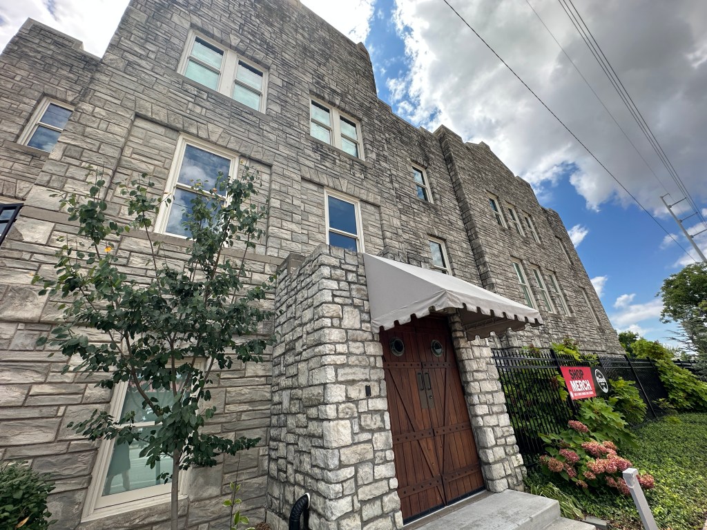 Exterior view of the historic Church Studio, featuring its stone facade, windows, and entrance.