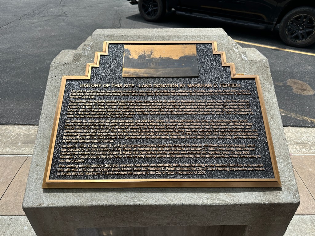 Historic marker plaque detailing the history of the Meadow Gold Sign site in Tulsa, Oklahoma.