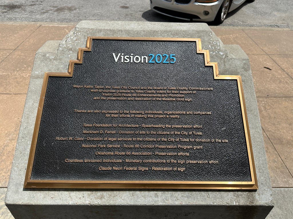 Plaque commemorating the Vision 2025 initiative in Tulsa, Oklahoma, highlighting support for the preservation and restoration of the historic Meadow Gold sign.