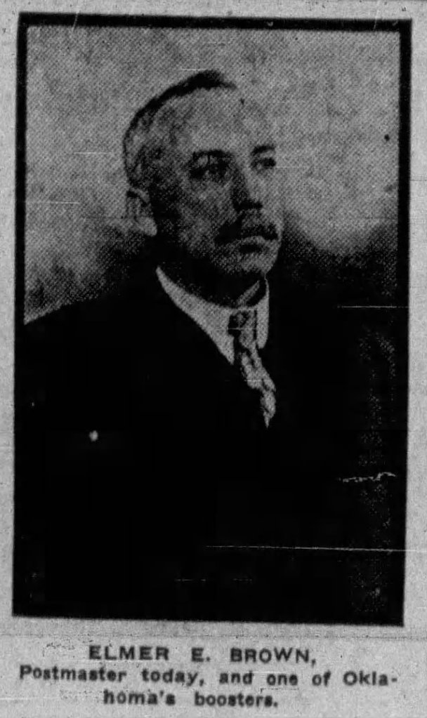 Black and white portrait of Elmer E. Brown, postmaster, with a mustache and wearing a suit, displaying a serious expression.