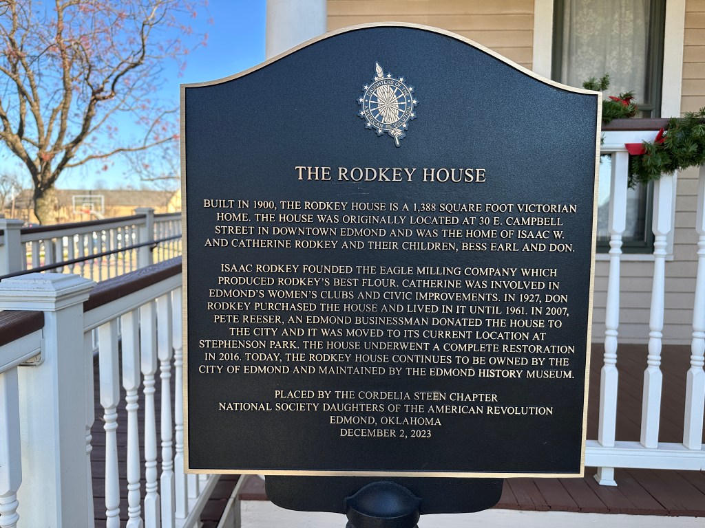 Historic plaque detailing the history of the Rodkey House, a Victorian home built in 1900, located in Edmond, Oklahoma.