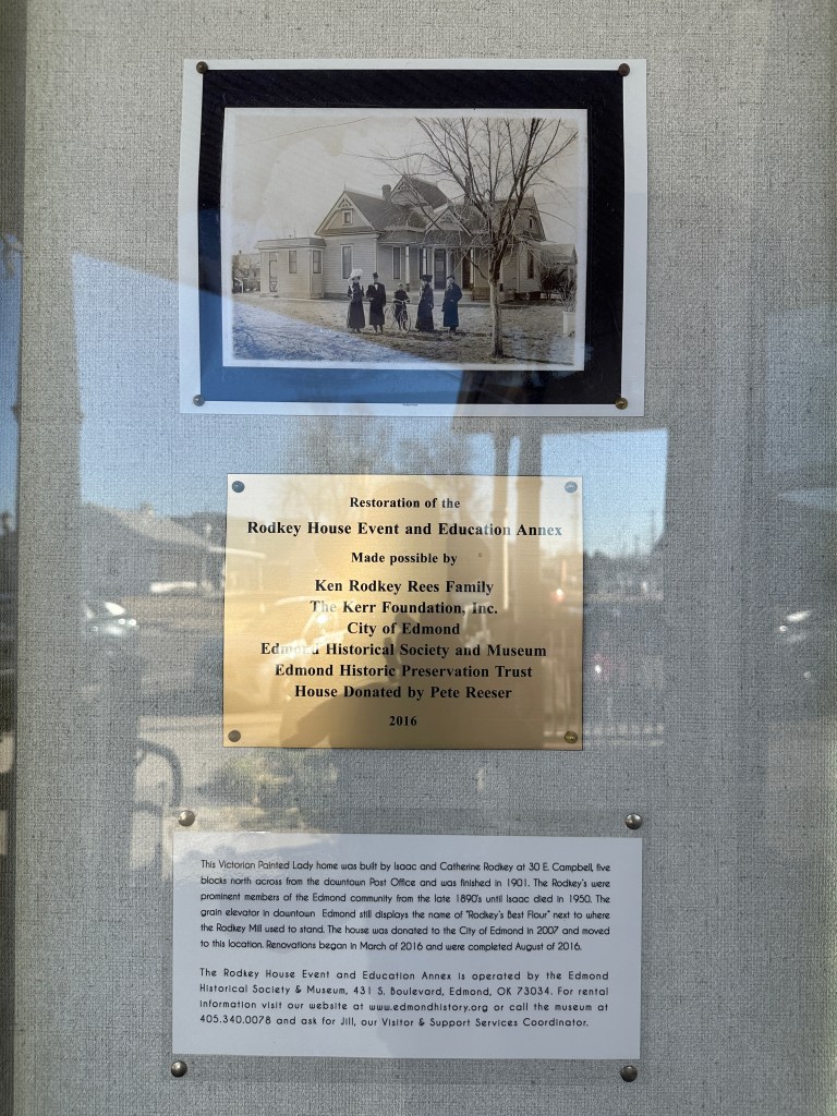 Historic restoration sign for the Rodkey House Event and Education Annex, featuring a sepia-toned photograph of the house and original residents.