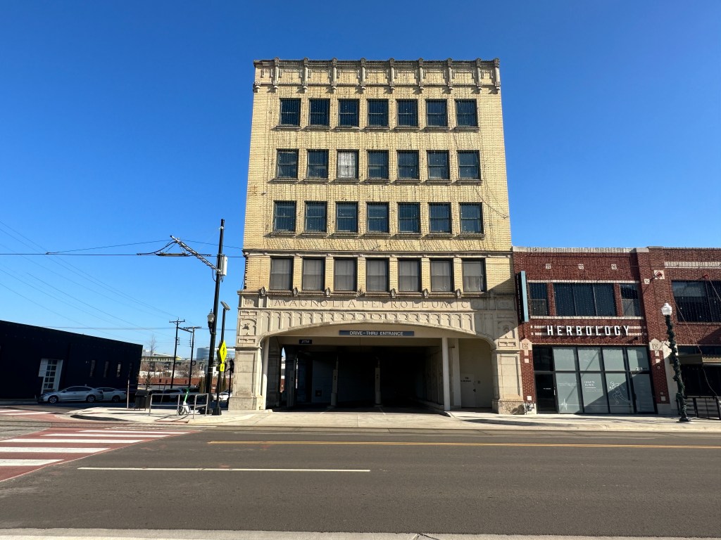 Front view of the Magnolia Petroleum Company building in Oklahoma City, showcasing its five-story Sullivanesque architecture with limestone and blonde brick exterior.