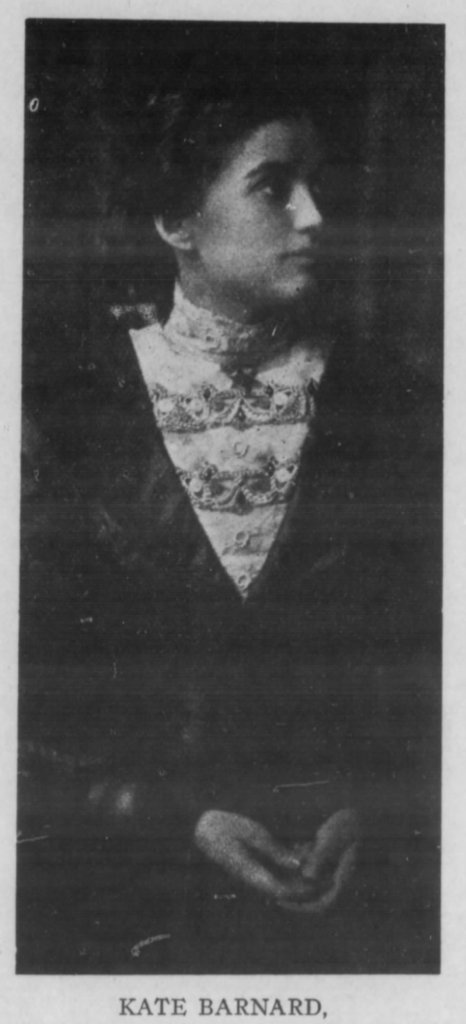 Profile portrait of a young woman named Kate Barnard, wearing a decorative blouse and an elegant dark dress, with her hands clasped in front.