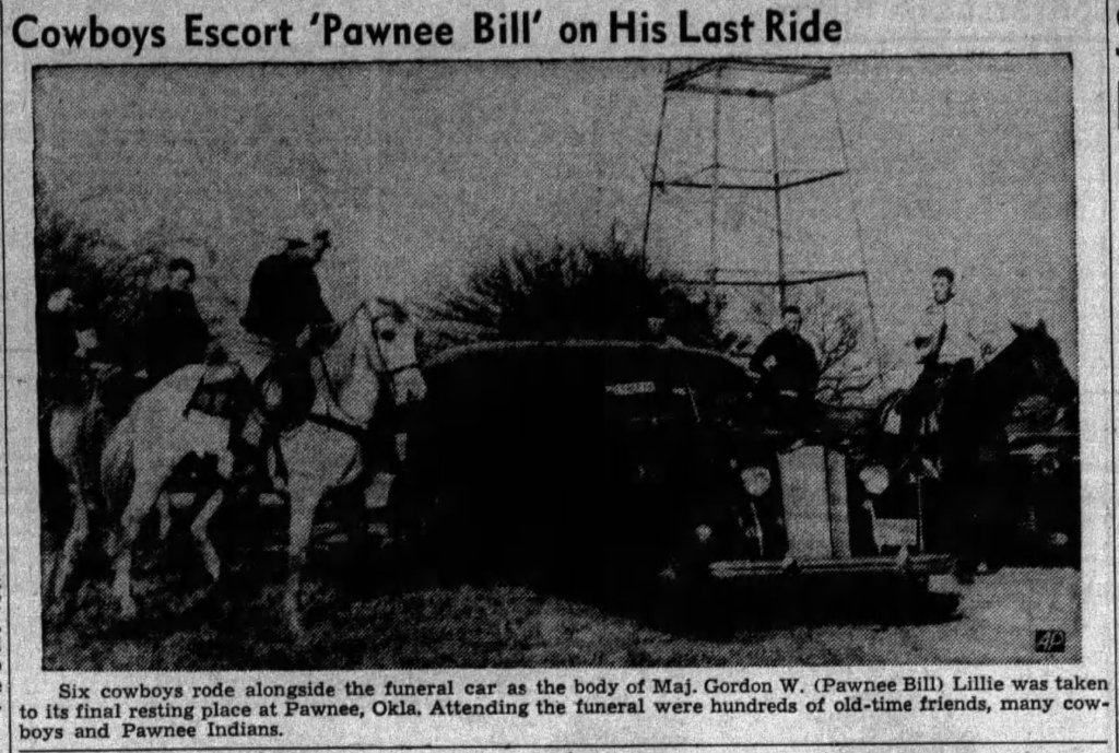 Six cowboys escort a funeral car, honoring Maj. Gordon W. 'Pawnee Bill' Lillie, during his last ride, with a backdrop of trees and a tower.